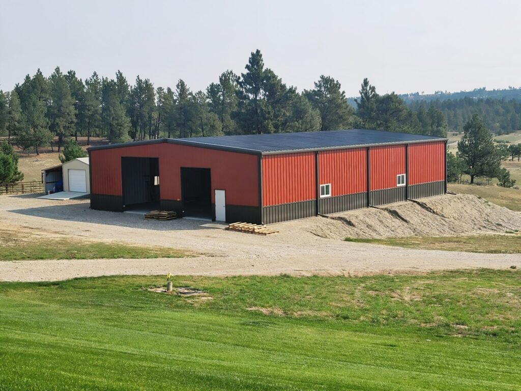 Large red and black pre-engineered metal building for commercial or warehouse use
